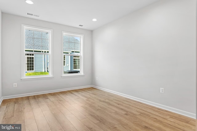 spare room featuring baseboards, recessed lighting, visible vents, and light wood-style floors