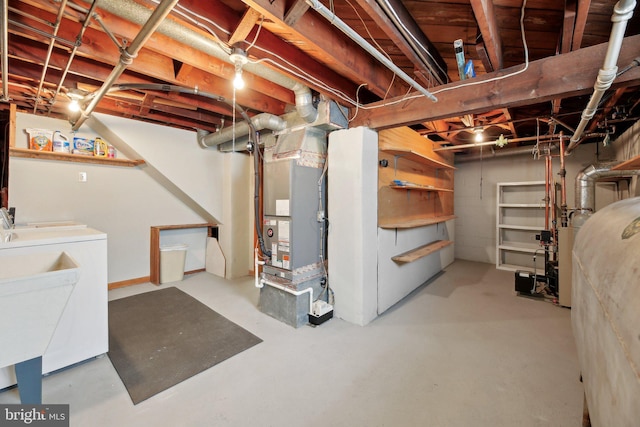 unfinished basement featuring heating unit and washing machine and dryer