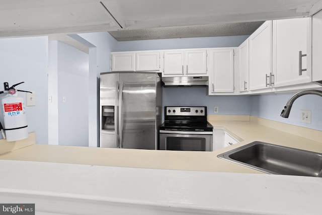 kitchen with appliances with stainless steel finishes, light countertops, under cabinet range hood, white cabinetry, and a sink