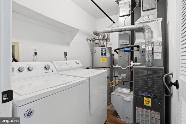 laundry room with laundry area, dark wood-style flooring, gas water heater, and washing machine and clothes dryer