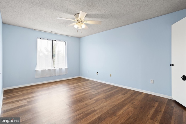 empty room featuring dark wood-style flooring, ceiling fan, a textured ceiling, and baseboards