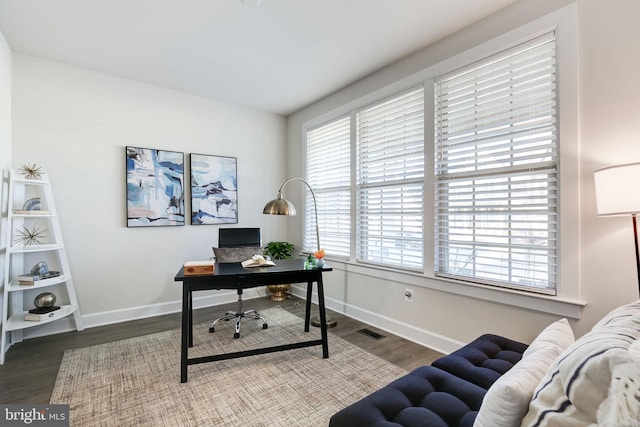 office featuring visible vents, baseboards, and wood finished floors