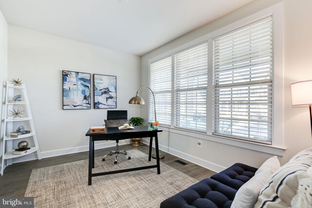 office area featuring wood finished floors, visible vents, and baseboards