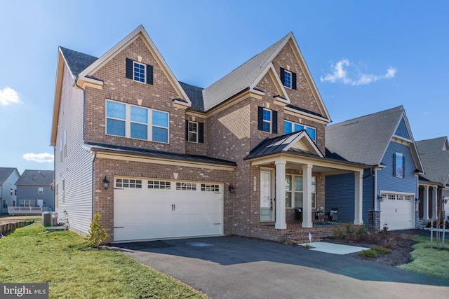 traditional-style house featuring aphalt driveway, brick siding, covered porch, a garage, and cooling unit