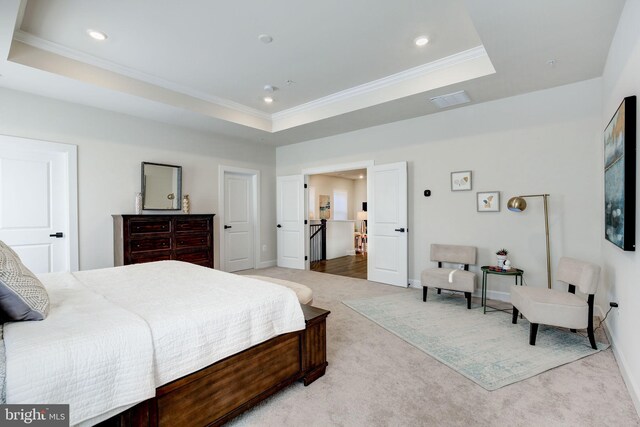 bedroom with recessed lighting, a raised ceiling, crown molding, and light colored carpet