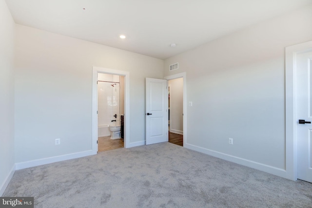 unfurnished bedroom with baseboards, visible vents, connected bathroom, carpet flooring, and recessed lighting