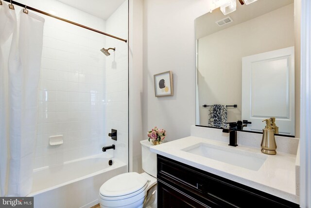 full bathroom featuring toilet, vanity, visible vents, and shower / tub combo with curtain