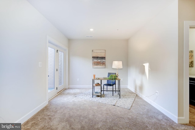 unfurnished dining area with a wealth of natural light, carpet flooring, visible vents, and baseboards