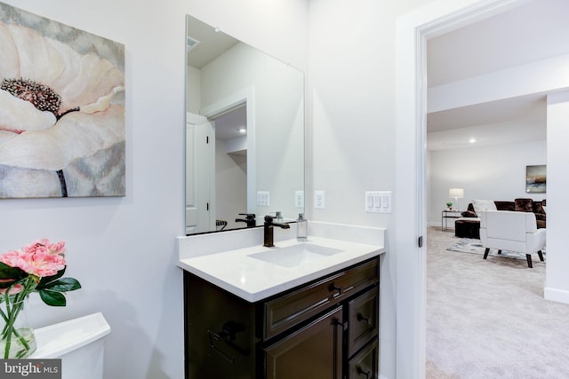 half bathroom featuring toilet and vanity