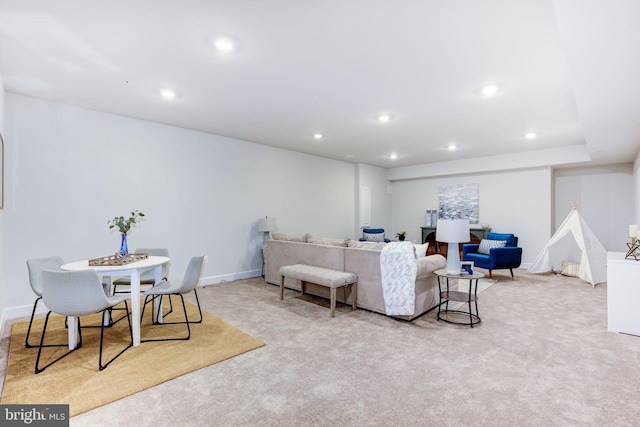 carpeted living area with recessed lighting and baseboards