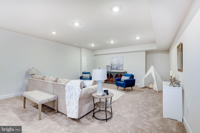 living room featuring recessed lighting, light carpet, and baseboards