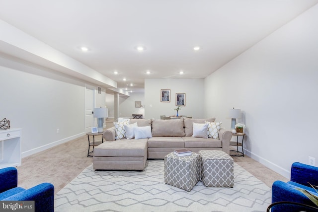 living room featuring recessed lighting, baseboards, and light colored carpet