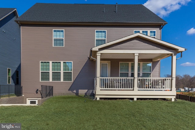 rear view of property with a porch and a lawn