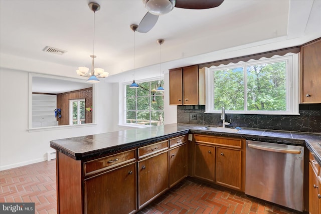444 Rocksville Rd, Holland, PA 18966 - kitchen with stainless steel dishwasher, a sink, brick floors, a peninsula, and decorative backsplash
