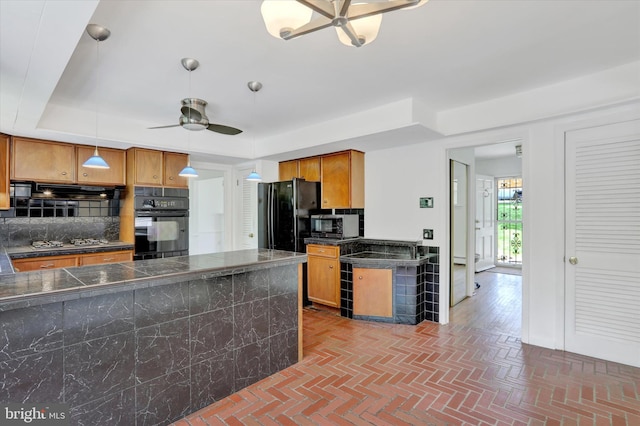 444 Rocksville Rd, Holland, PA 18966 - kitchen featuring black appliances, a ceiling fan, brick patterned flooring, brown cabinetry, and backsplash