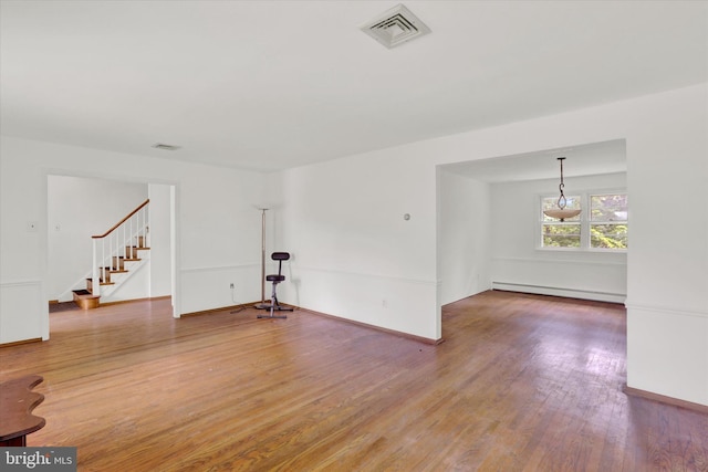 444 Rocksville Rd, Holland, PA 18966 - spare room with a baseboard radiator, wood finished floors, stairs, and baseboards