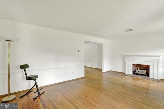 444 Rocksville Rd, Holland, PA 18966 - unfurnished living room featuring wood finished floors, a fireplace with raised hearth, and baseboards
