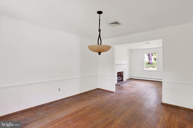 444 Rocksville Rd, Holland, PA 18966 - unfurnished dining area featuring baseboard heating, wood finished floors, baseboards, and a fireplace with raised hearth