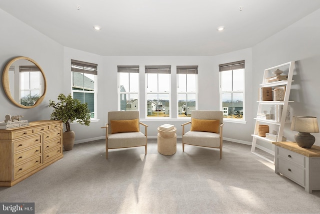 sitting room with recessed lighting, baseboards, and light carpet