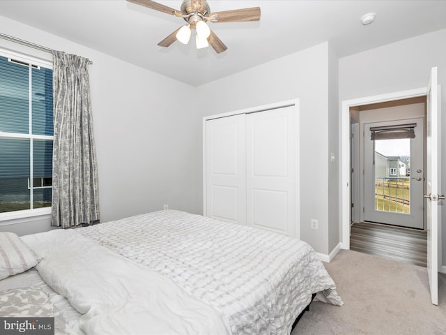 carpeted bedroom with baseboards, a closet, and ceiling fan