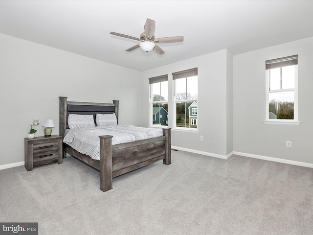 bedroom featuring baseboards, carpet floors, and a ceiling fan