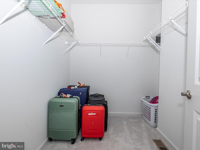 walk in closet featuring visible vents and carpet floors