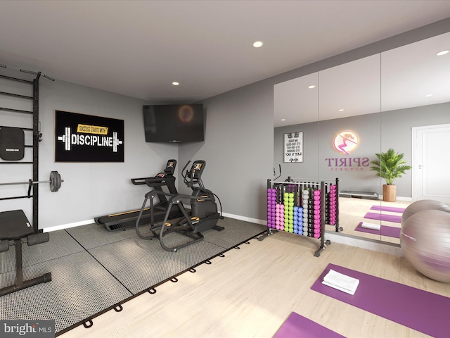 exercise room featuring recessed lighting, baseboards, and wood finished floors