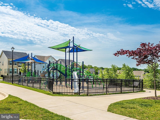 communal playground with a residential view and fence