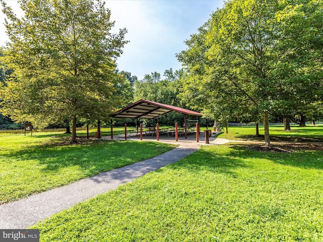 surrounding community with a gazebo, a lawn, and a carport