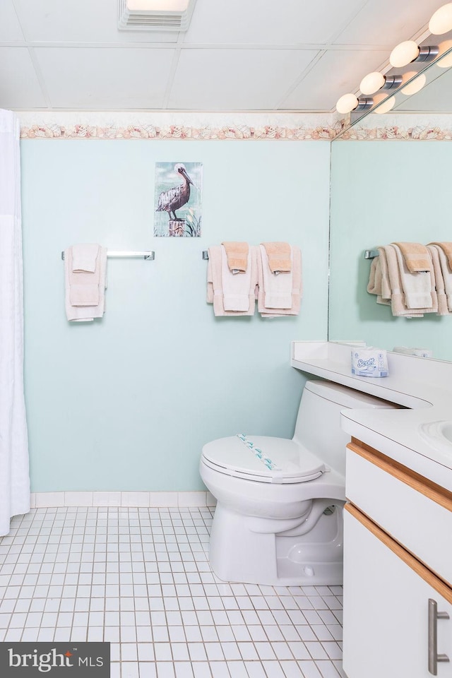 bathroom with tile patterned flooring, toilet, visible vents, vanity, and baseboards