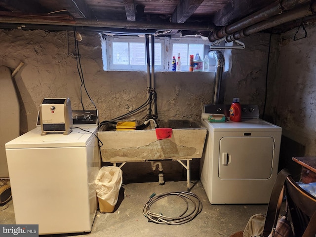 washroom featuring washer and dryer, laundry area, and a sink