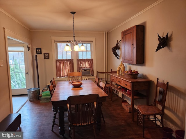 dining area with an inviting chandelier, dark wood-style floors, and ornamental molding