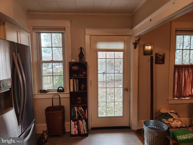 entryway with a wealth of natural light and crown molding