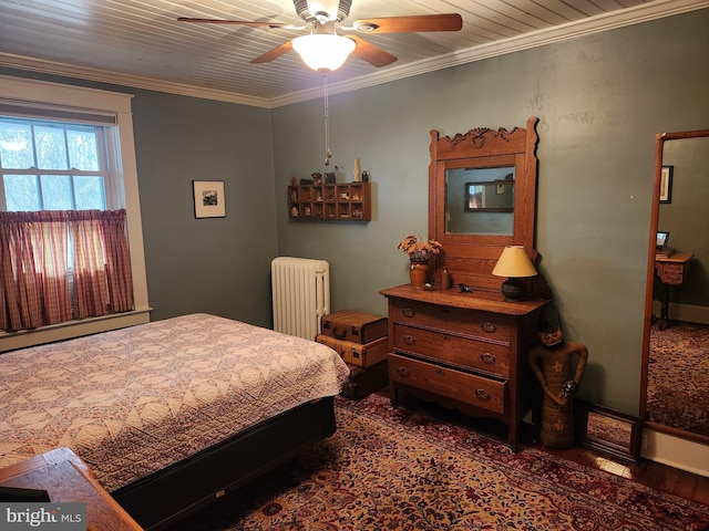 bedroom featuring wood finished floors, radiator, crown molding, and ceiling fan