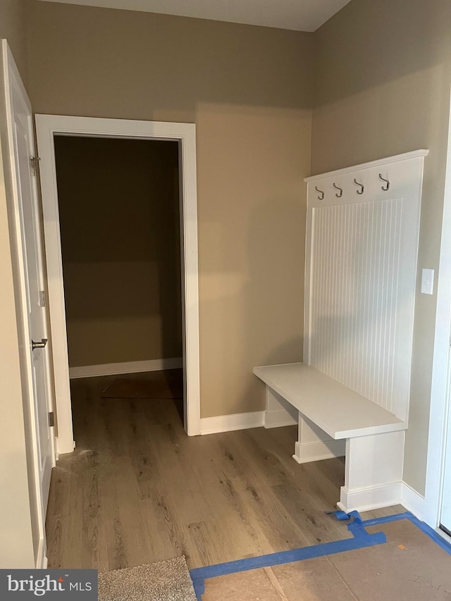 mudroom featuring wood finished floors and baseboards