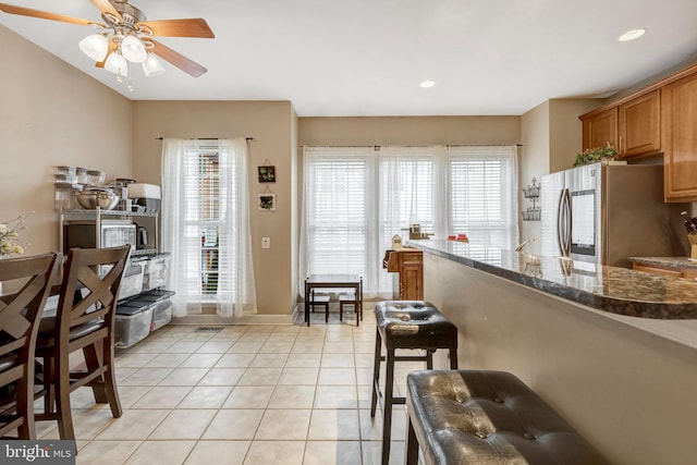 kitchen featuring ceiling fan, dark stone counters, recessed lighting, smart refrigerator, and light tile patterned flooring