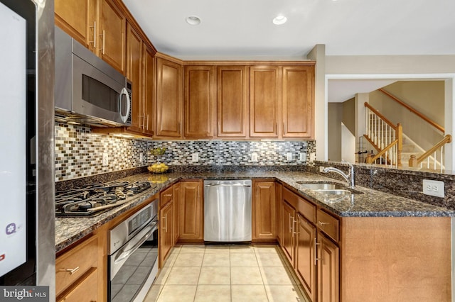 kitchen featuring a sink, brown cabinetry, and stainless steel appliances