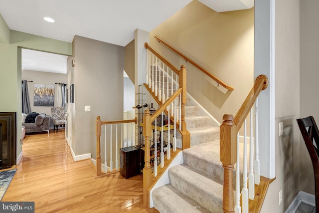 stairs featuring recessed lighting, baseboards, and wood finished floors