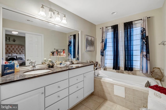 bathroom featuring visible vents, double vanity, tile patterned floors, ensuite bath, and a sink