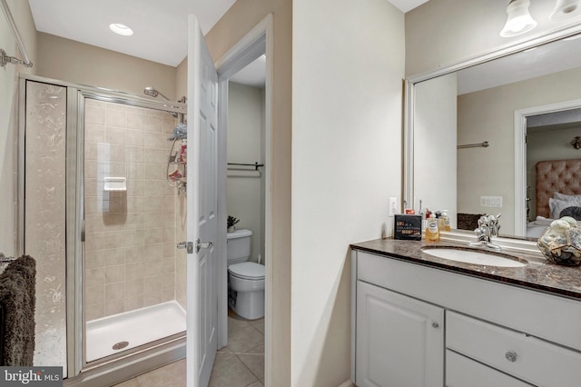 full bath featuring toilet, a stall shower, connected bathroom, tile patterned flooring, and vanity