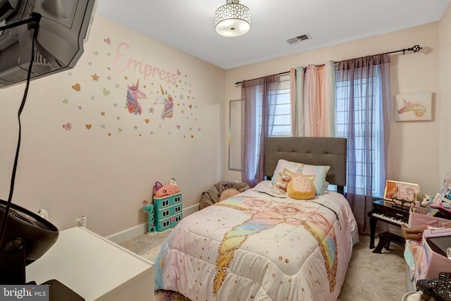 bedroom featuring visible vents, baseboards, and carpet