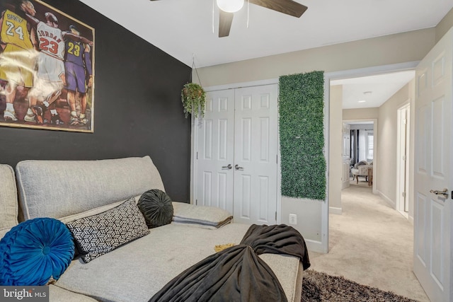 carpeted bedroom featuring a closet, ceiling fan, and baseboards