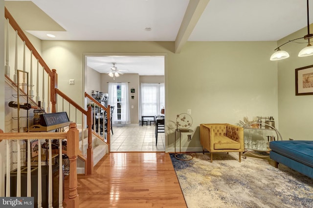 entryway featuring stairs, wood finished floors, baseboards, and ceiling fan