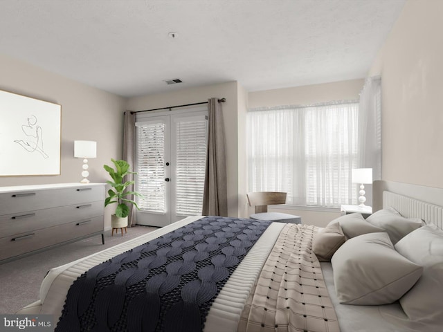 carpeted bedroom with visible vents, french doors, and access to outside