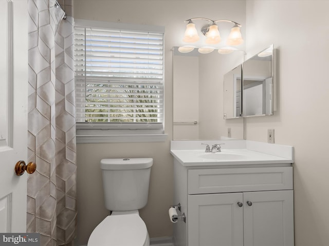 bathroom featuring toilet and vanity