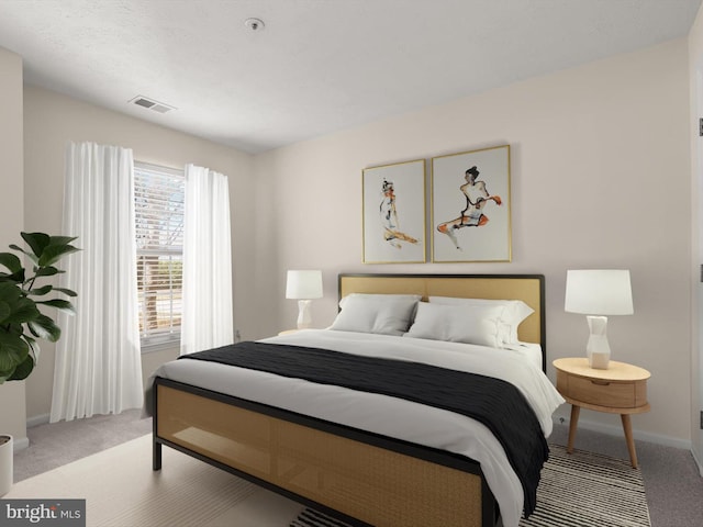 bedroom with visible vents, light carpet, and baseboards