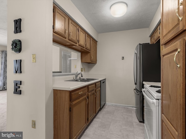 kitchen featuring electric range, a sink, a textured ceiling, light countertops, and dishwasher