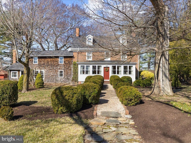 view of front of house featuring a chimney