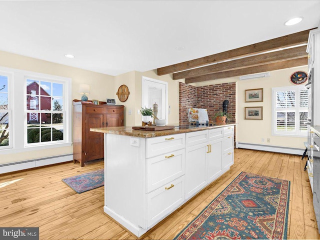 kitchen featuring a baseboard radiator, a baseboard heating unit, white cabinets, light wood-type flooring, and beamed ceiling