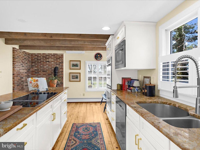 kitchen featuring stainless steel appliances, baseboard heating, a sink, light wood-type flooring, and beamed ceiling